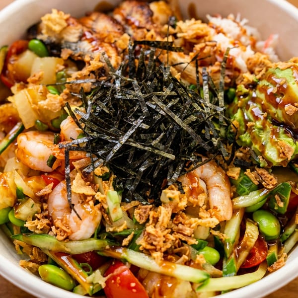Fresh poke bowl with shrimp, avocado, seaweed, edamame, cucumber, and crispy fried onions.